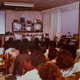 Women with permed hair watch television in the 1980s.